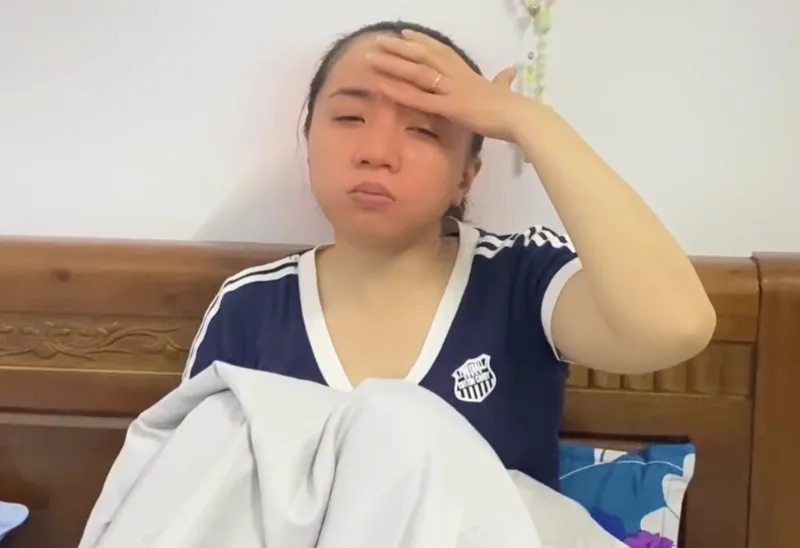 A woman with her hand on her forehead